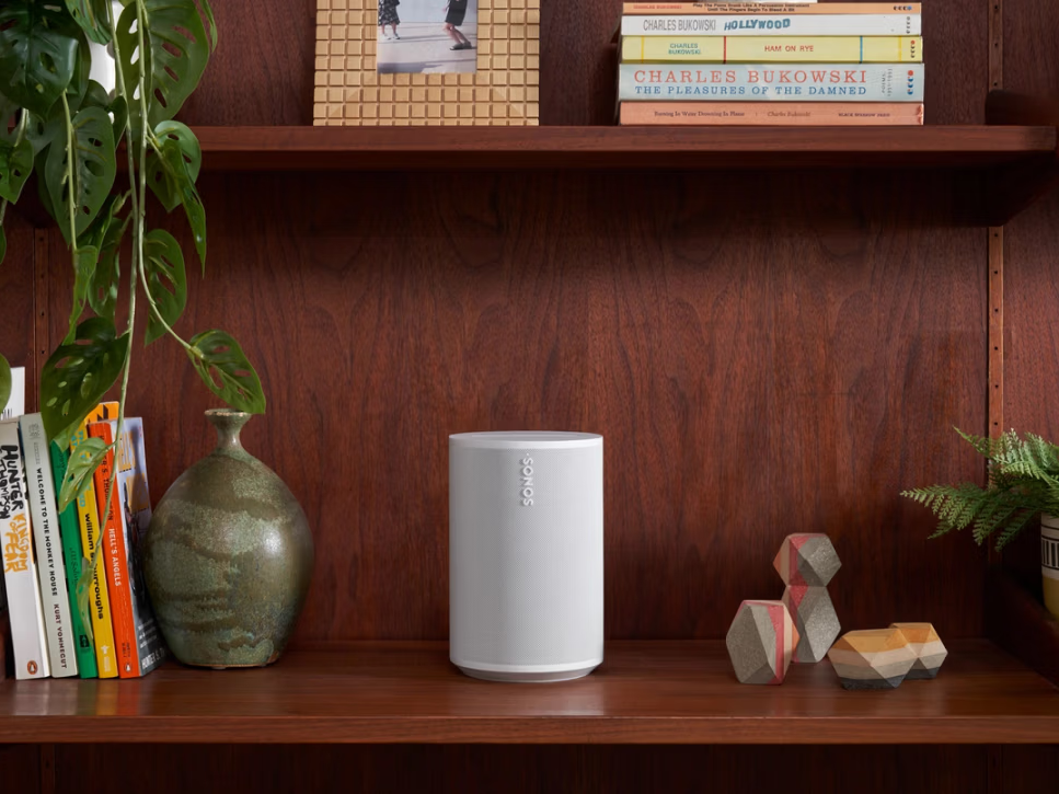 Sonos Era 100 smart speaker on bookshelf